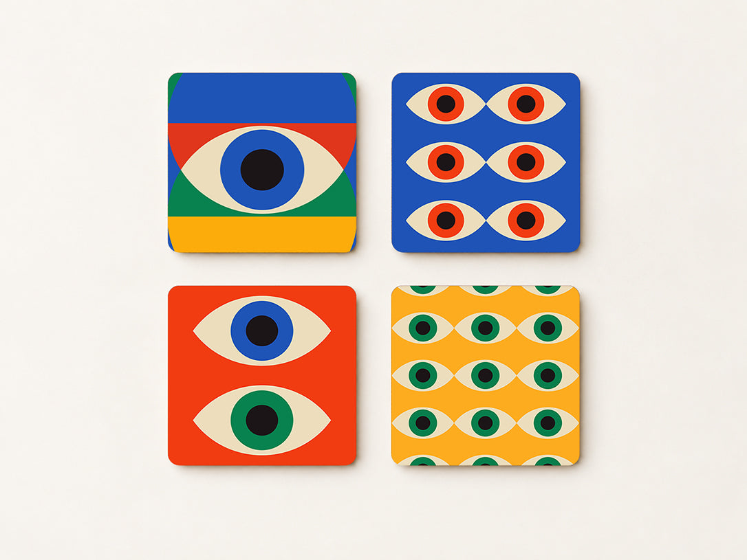 Set of 4 square cork coasters with colorful Bauhaus geometric eye patterns on light background